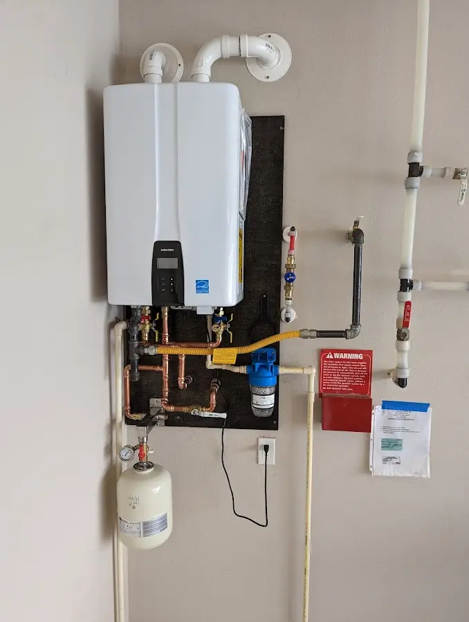 Professional plumber installing copper piping in a Midland home